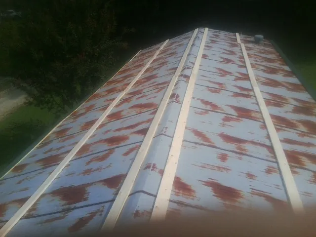 Rusted metal roof panels with new wood purlins before replacement — Storm Damage Roof Repair in Westerlo by Roofing Brothers